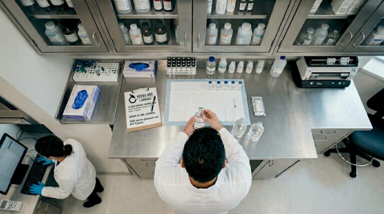Pharmacist preparing sterile solutions in pharmacy