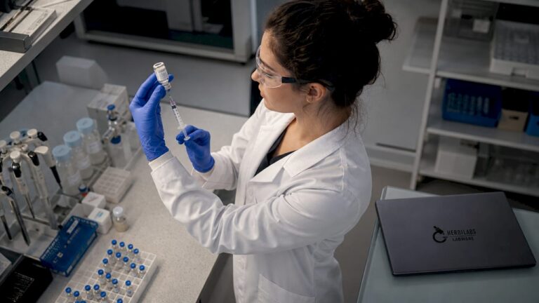 Scientist preparing injectable research reagent in lab